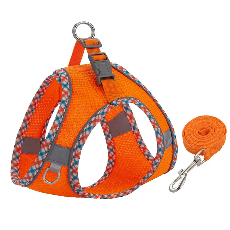 Orange reflective adjustable dog harness and leash set with a silver clip