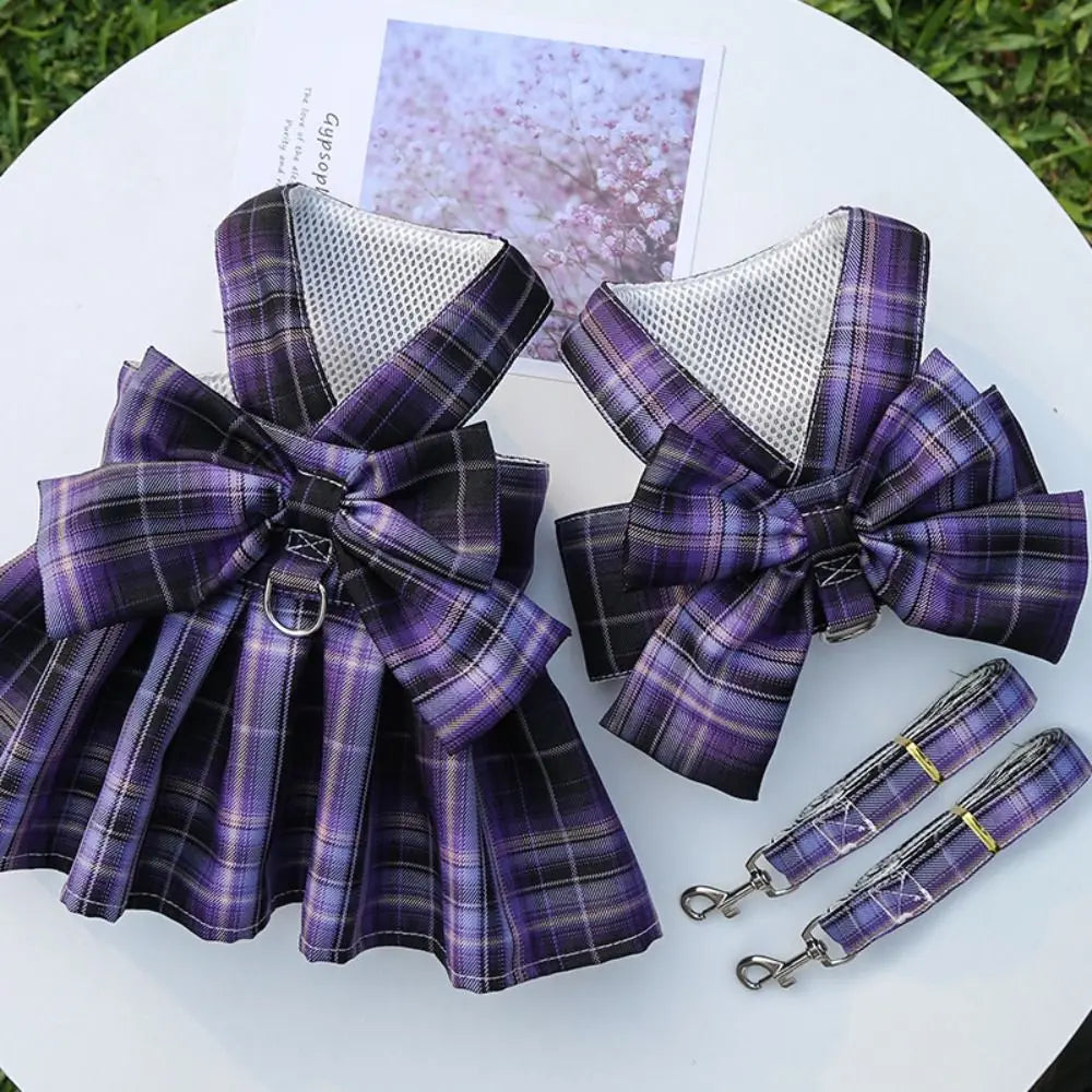A purple and black plaid reusable dog harness dress with a mesh lining displayed on a white surface.