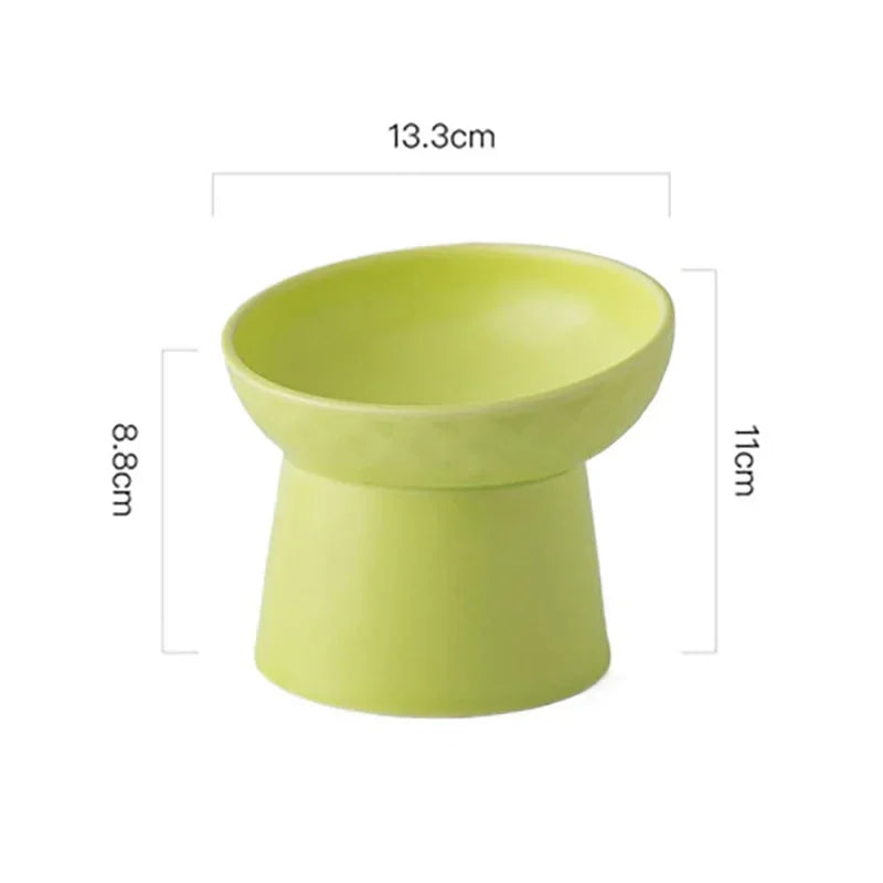 A light lime green elevated ceramic food bowl for pets, shown from the top view.