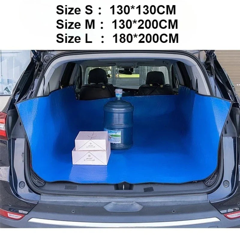 Blue waterproof car trunk mat with a pet barrier placed inside the trunk of a car.