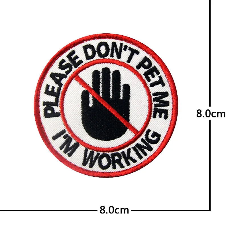Red and white embroidered patch with black text that reads Please Don't Pet Me I'm Working