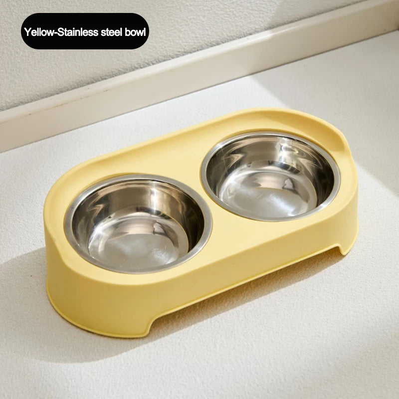 A yellow-colored elevated feeder stand with two stainless steel bowls for dogs or cats.