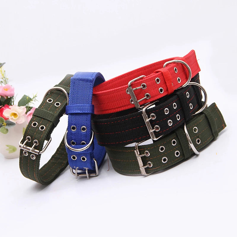 A stack of three heavy duty tactical dog collars in blue, red, and black nylon with metal buckles.