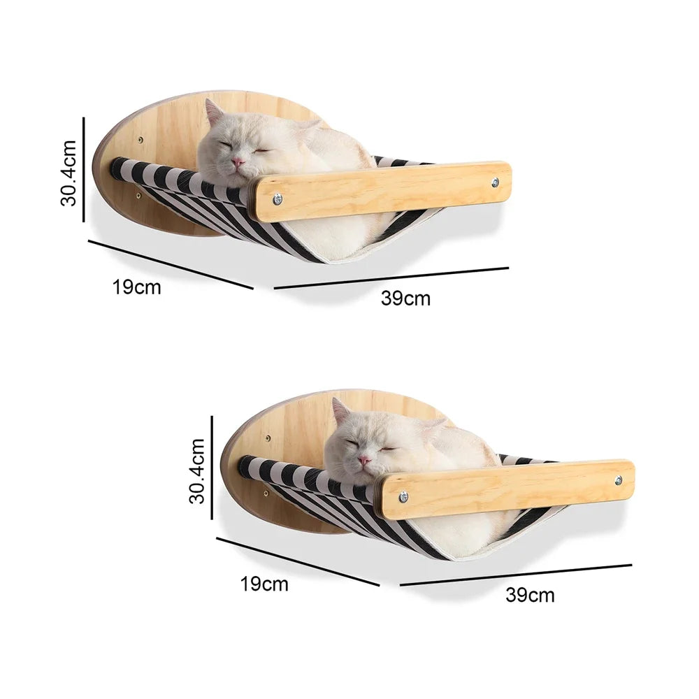 A fluffy white cat is relaxing in a wooden wall-mounted hammock with black and white stripes.