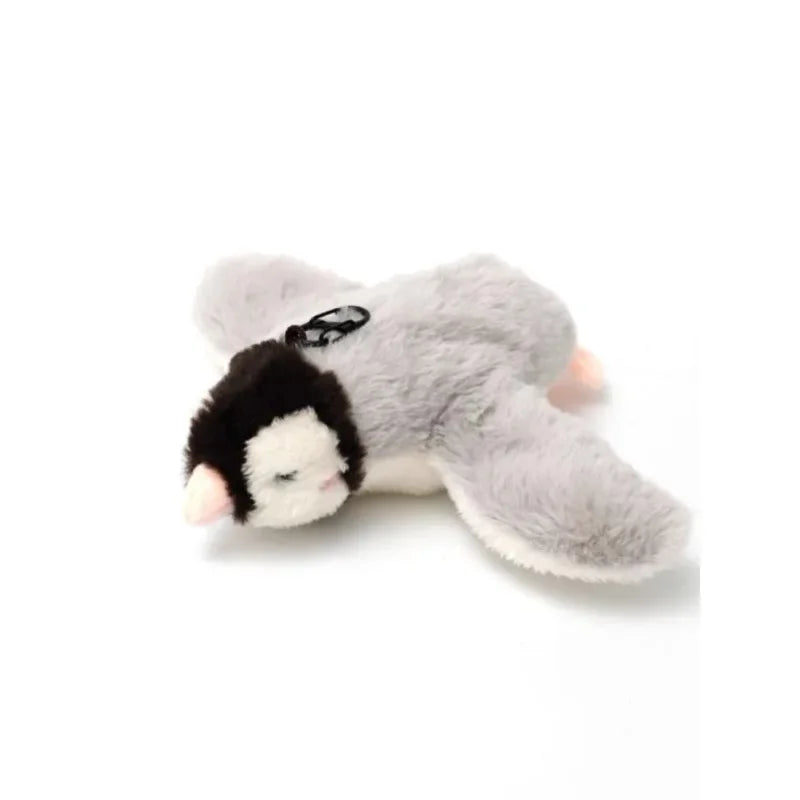 A soft, gray plush toy resembling a cat with black markings and an attached bird sound feature.