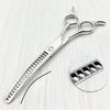 Silver professional pet grooming scissors with a serrated blade shown on a white surface.