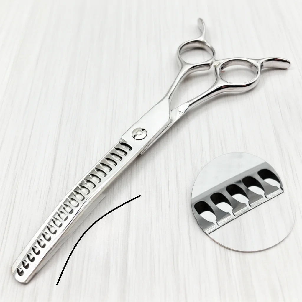 Silver professional pet grooming scissors with a serrated blade shown on a white surface.