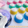 A variety of colorful, round pet talk buttons for dogs and cats are displayed on a white surface.