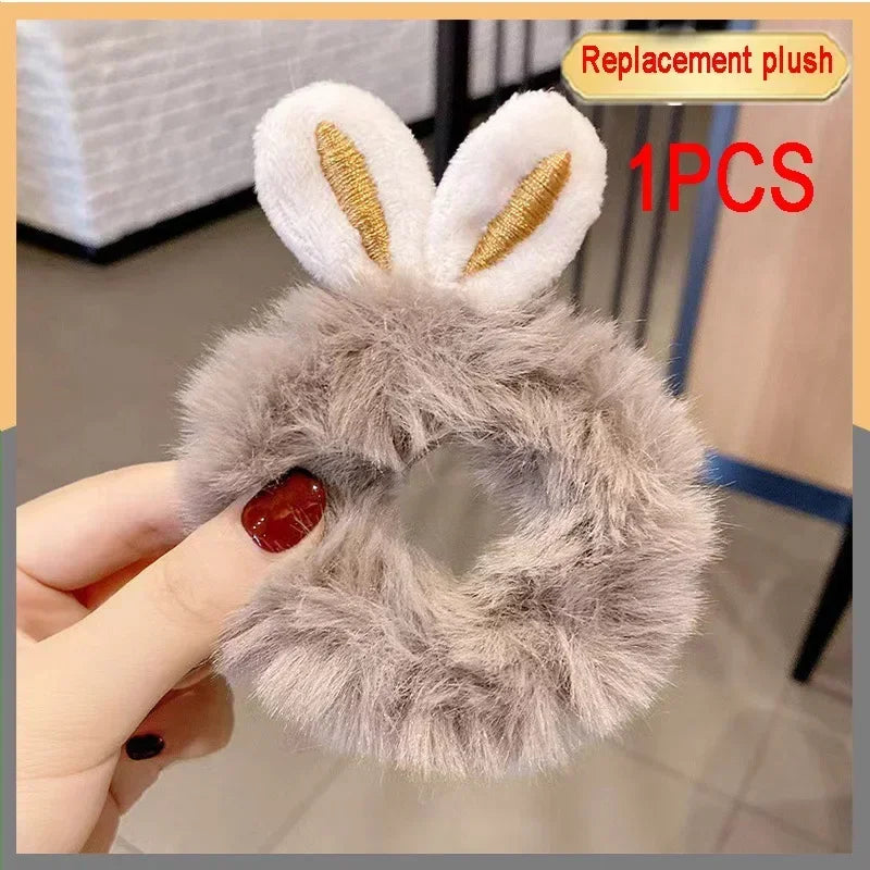 A replacement plush toy featuring white ears and gray fur, held by a hand.