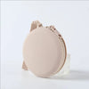 A light beige silicone pet treat pouch with a strap, shown against a white background.