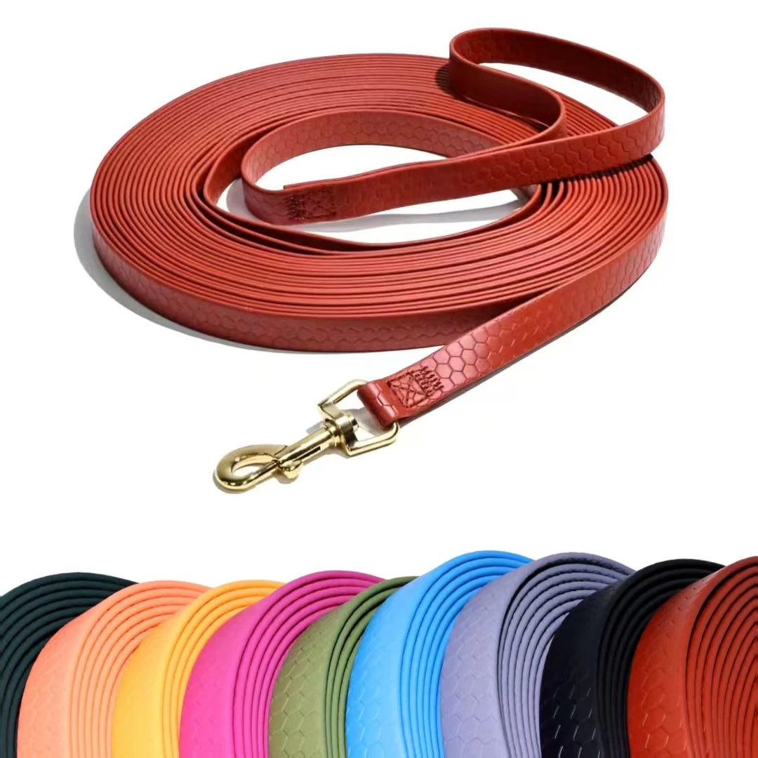 A roll of rustproof dog leash with a leather strap and metal hook, shown in various colors.