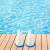 Two white pool filter bags are placed on a wooden surface next to clear blue water.