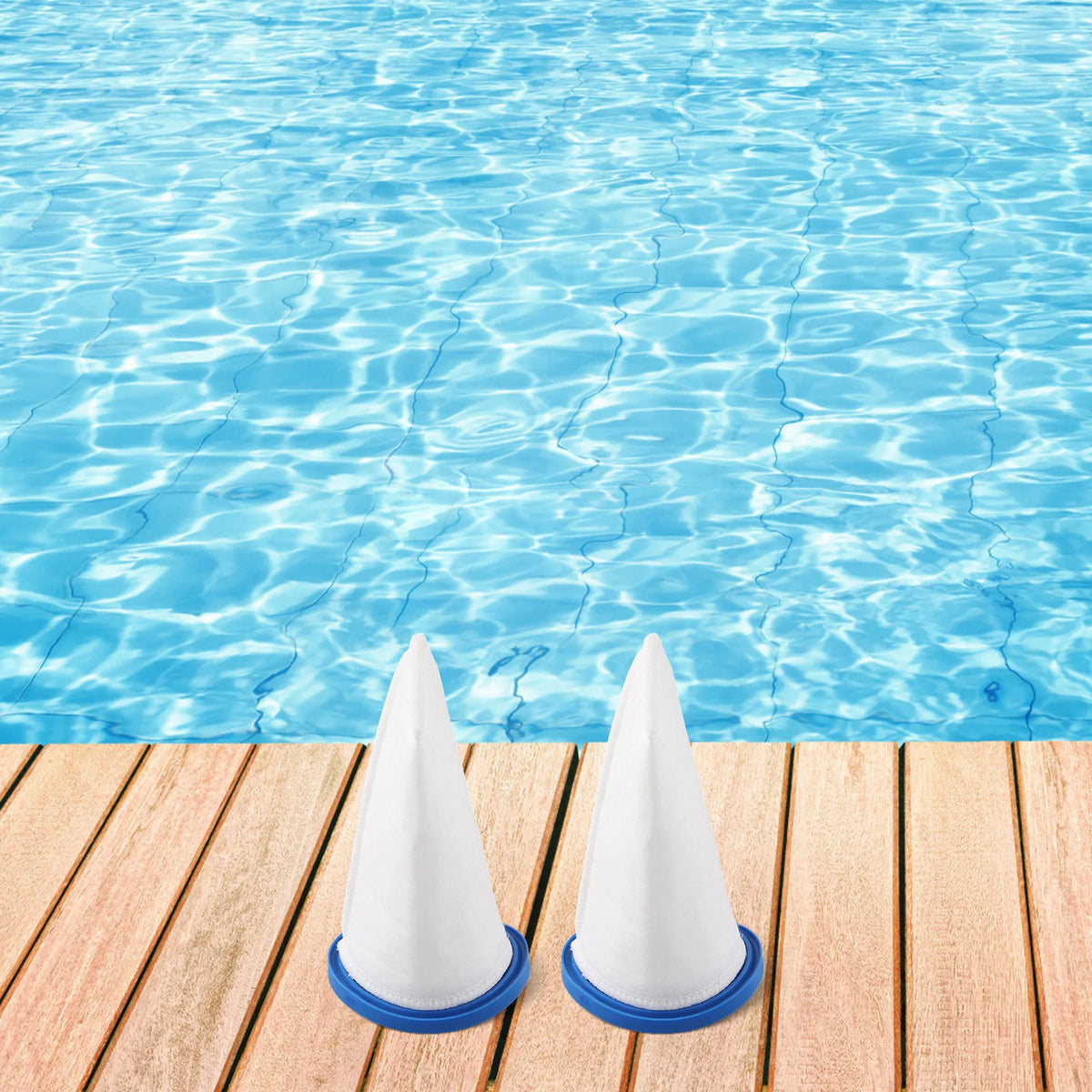 Two white pool filter bags are placed on a wooden surface next to clear blue water.