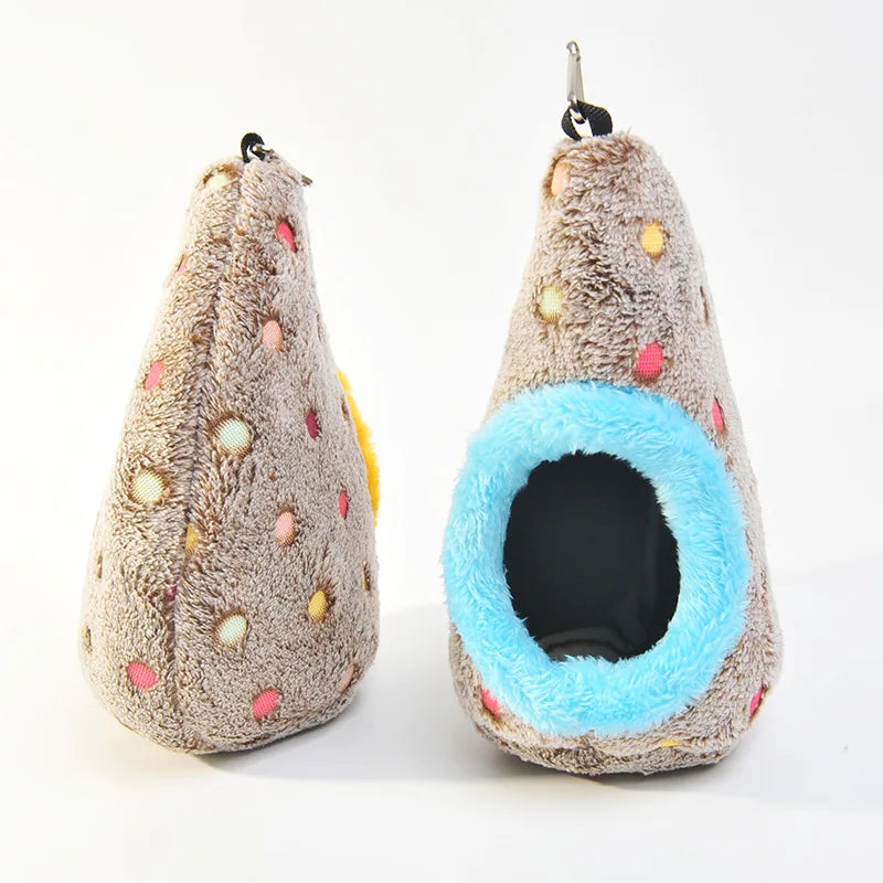 A fluffy, conical bird nest made of soft brown and beige cotton with colorful dots, designed for hanging.