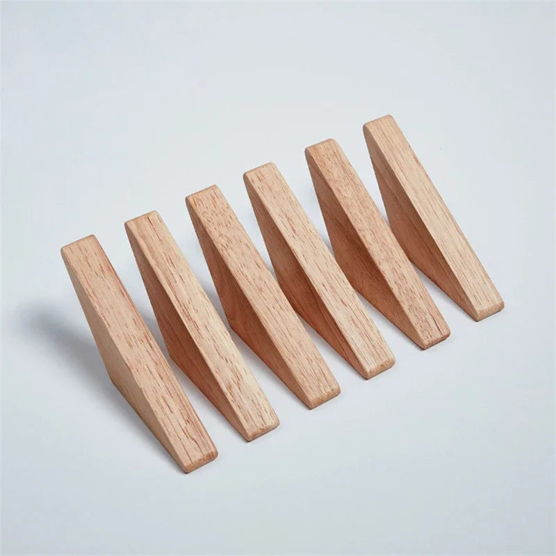 Five light brown oak wood triangle coat racks with hooks arranged diagonally on a white background