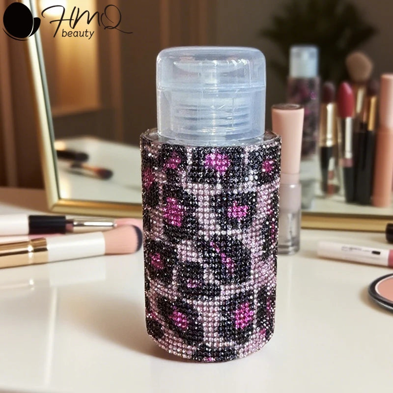A refillable diamond design pump bottle for nail polish remover and makeup with a black and pink glitter pattern.