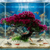 Lifelike artificial aquarium plant shaped like a vibrant pink and purple pine tree in an aquatic environment.