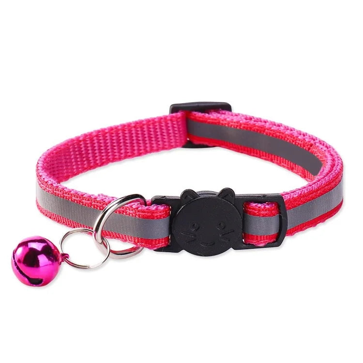 Pink and gray safety breakaway cat collar with a black charm and a pink bell.