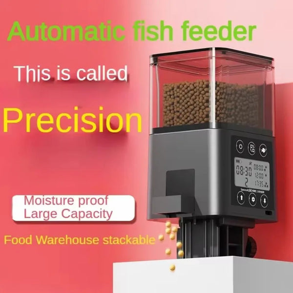 A black automatic fish feeder with a clear tank and LCD screen is shown on a white surface.