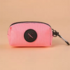 Pink fabric pouch with a black circular cross design and attached to a metal carabiner clip