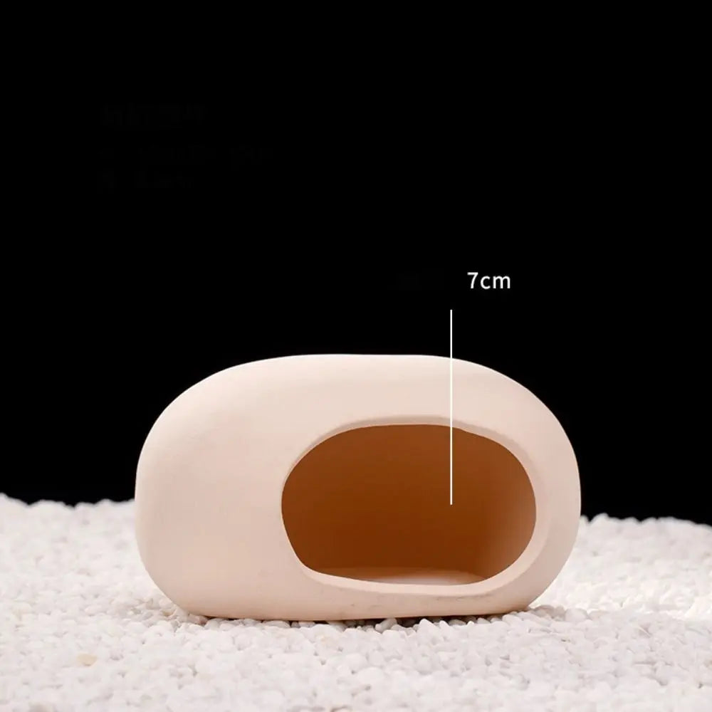 A beige ceramic aquarium shrimp hideaway cave with a 7cm dimension shown against a white background.