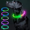 A black dog wearing a glowing, multi-colored LED collar with various light rings displayed beside it.