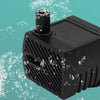 A black submersible aquarium water pump is shown against a teal background with splashing water.