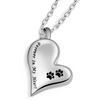 A silver stainless steel pet memorial necklace shaped like a heart with paw prints engraved on it.