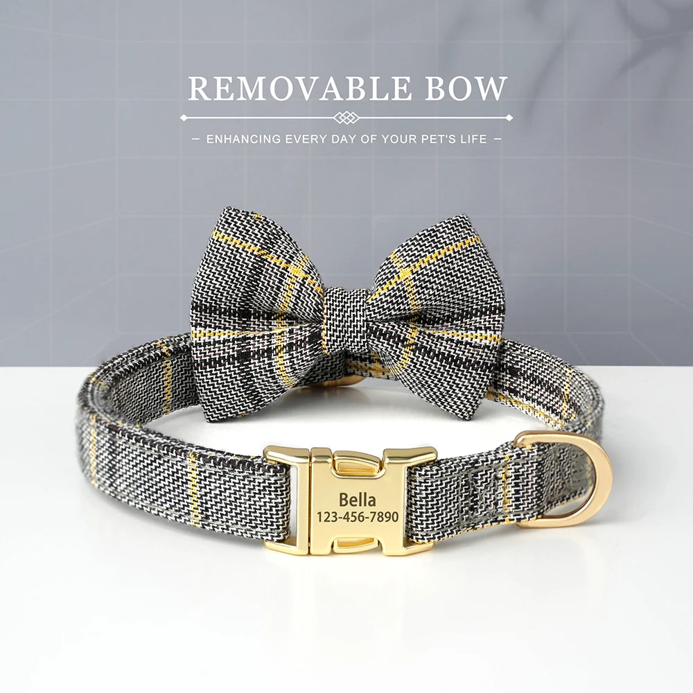 A black and gold plaid bowtie dog collar with a brass nameplate buckle.