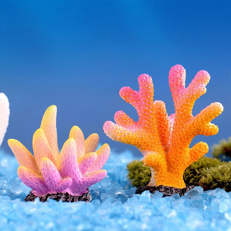 Colorful resin coral aquarium decoration featuring vibrant orange and pink hues on blue ice.