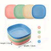 A set of non-slip shallow cat bowls in various pastel colors, including pink, green, beige, and blue.