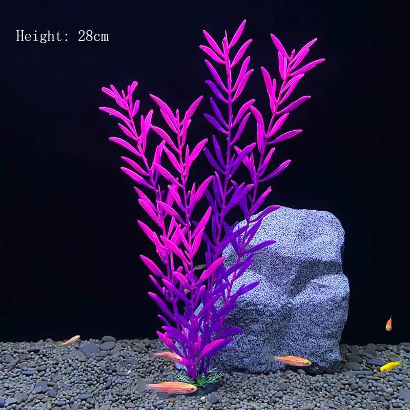 A tall, vibrant magenta artificial aquarium plant stands next to a gray rock on a dark gravel surface.