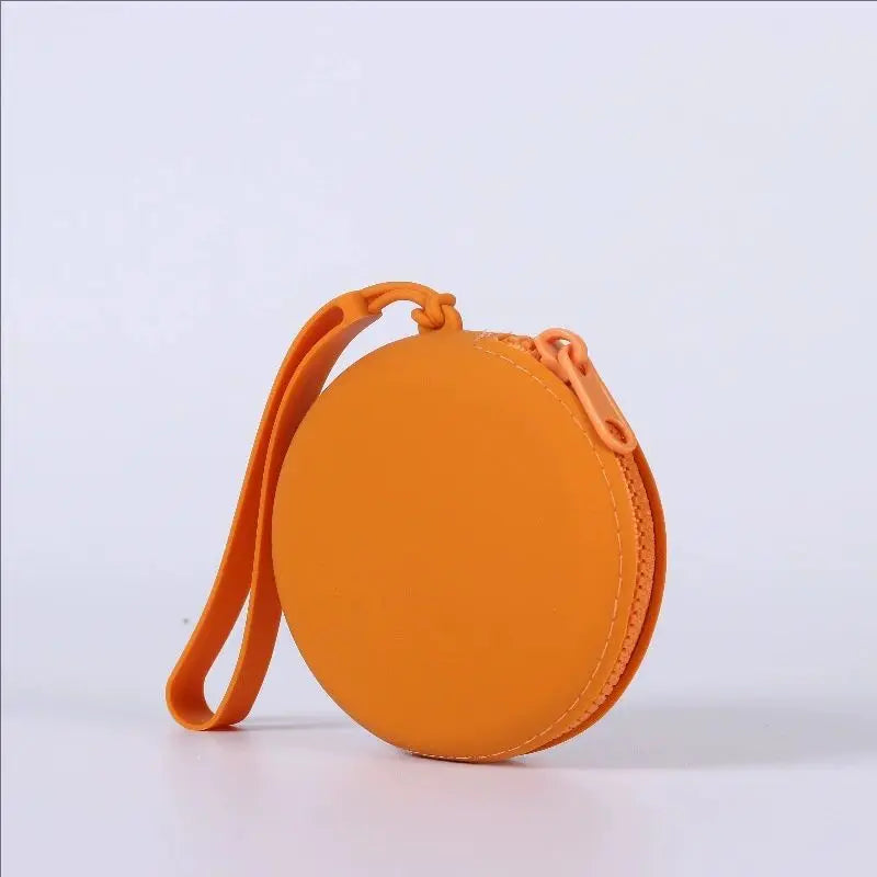 Orange silicone pet treat pouch with a loop for training and travel