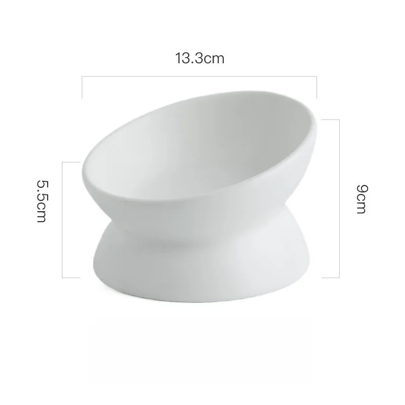 White ceramic cat bowl with a raised stand, measuring 13.3cm long and 9cm high.