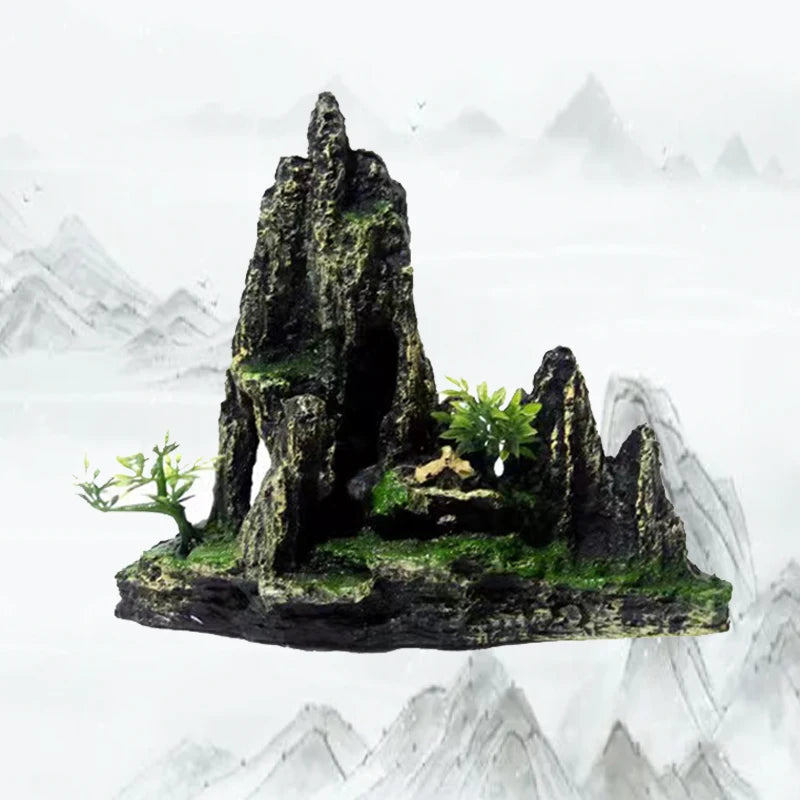 A resin aquarium rockery featuring a dark cave structure and a small green tree on a mossy rock amidst misty mountains.