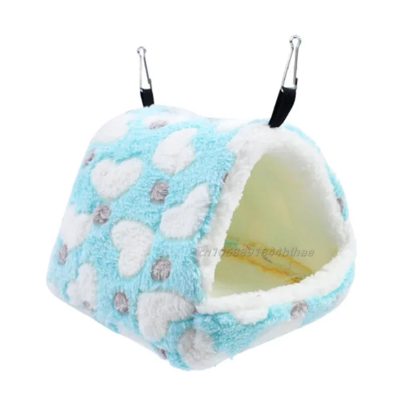 A fluffy light blue and white fleece pet nest bed with hanging ears.