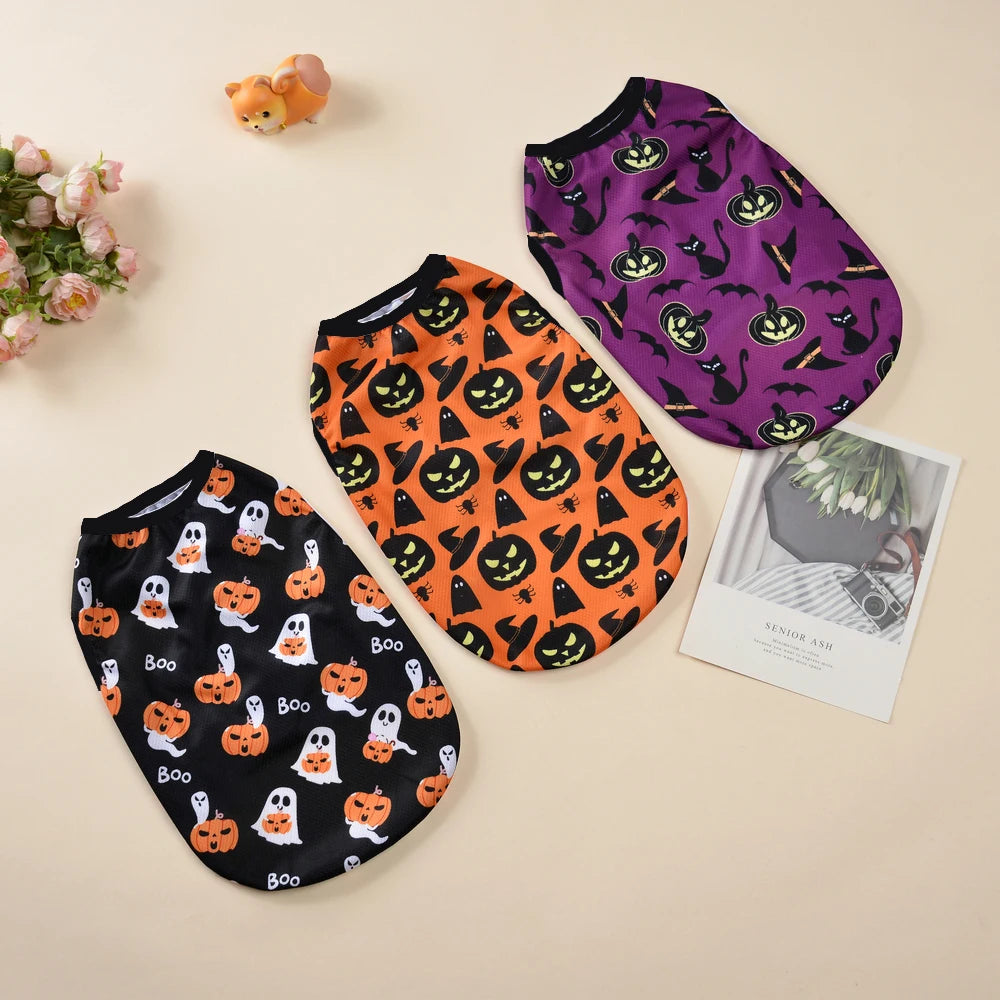 Three patterned pet shirts featuring Halloween pumpkin designs in purple, orange, and black.