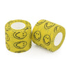 Eine Rolle gelben Stoffes mit schwarzen Smiley-Muster als selbstklebendes Tattoo-Grip-Verband.