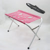 Pink foldable pet grooming hammock station with a black strap and silver frame.