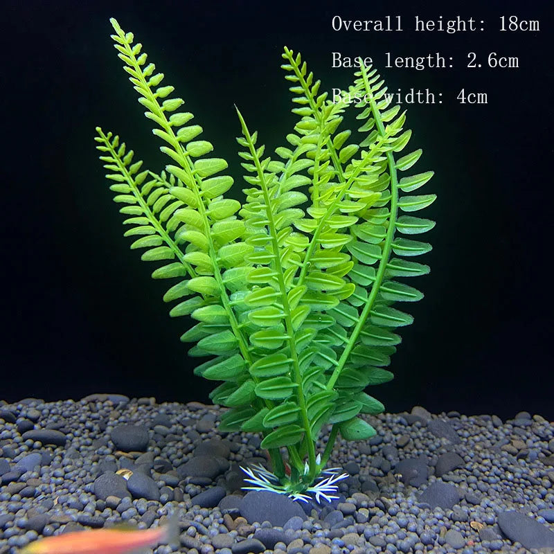 A vibrant green artificial aquarium plant with feathery fronds is rooted in dark gravel.