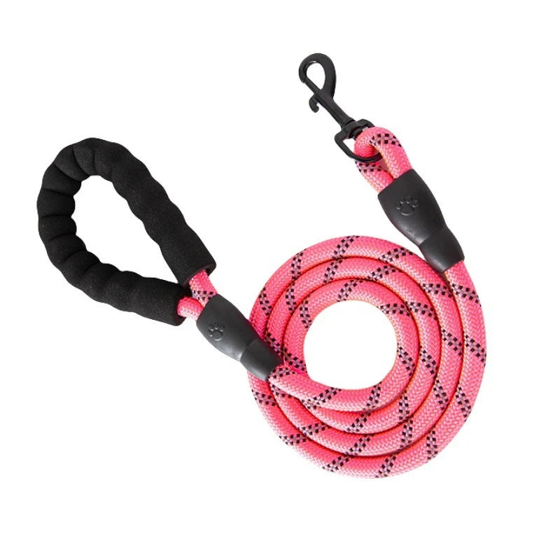 A pink and black reflective dog leash with a padded handle coiled in the center.