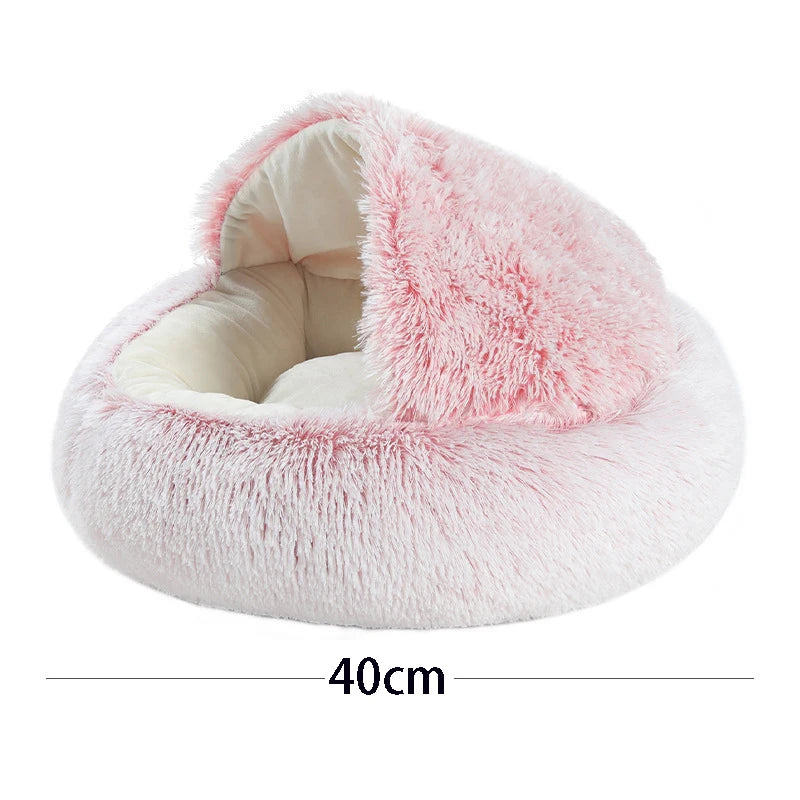 A fluffy pink plush pet bed for cats and small dogs with a removable cover.