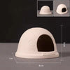 A beige ceramic aquarium shrimp hideaway cave with an arched entrance and a flat base.