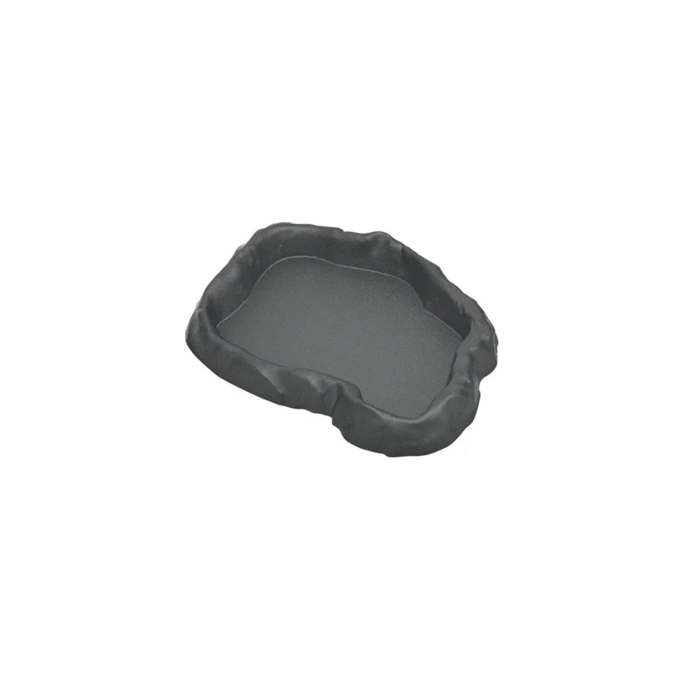 A dark gray, irregularly shaped dish designed for feeding or holding water for reptiles.