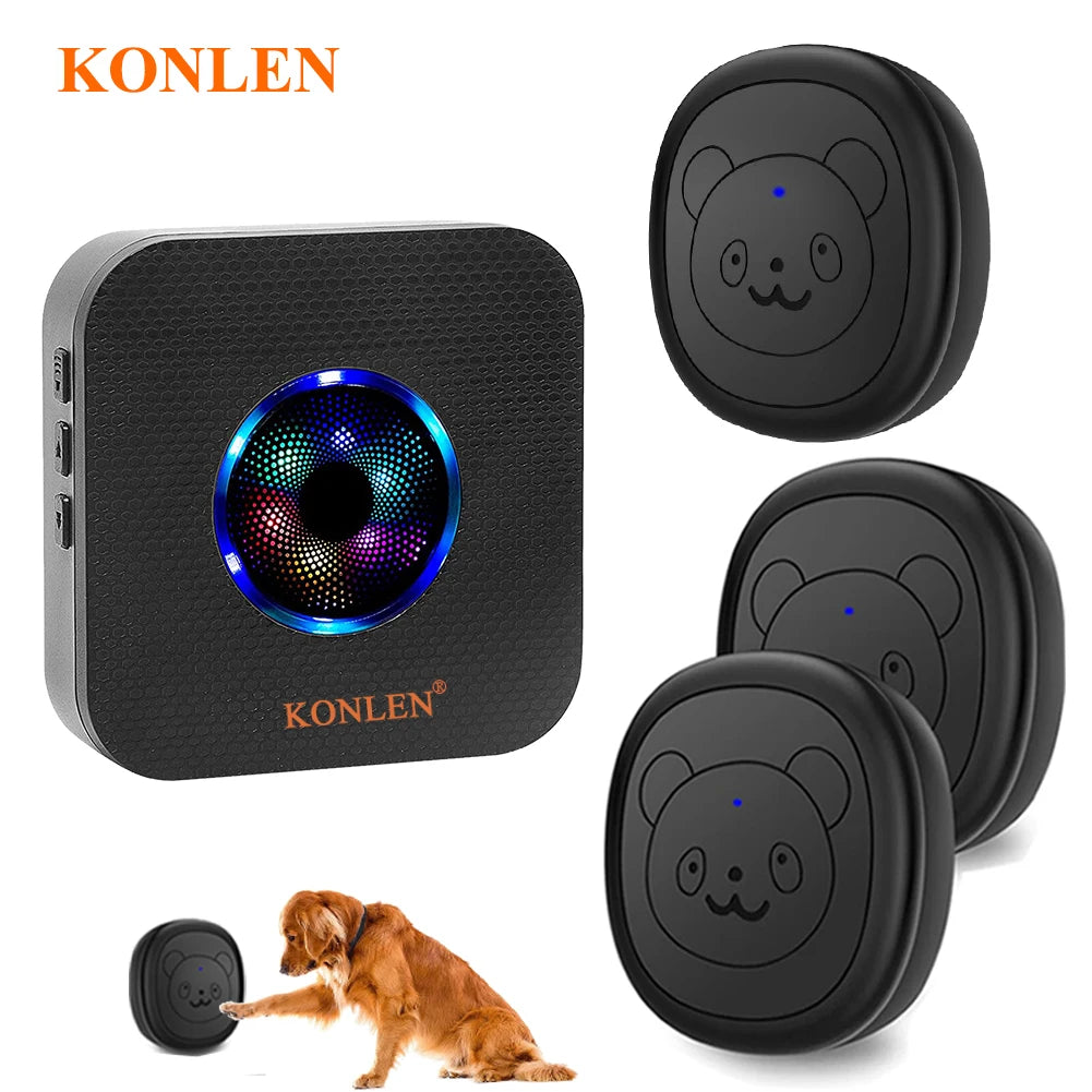 A black wireless dog doorbell unit and two round silicone training pads are shown with a dog.