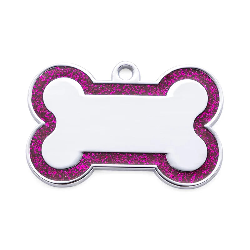 A silver dog bone shaped pet ID tag with a pink glitter border and a blank center.