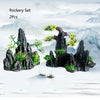 A set of two resin aquarium rockery pieces featuring dark rocks and green foliage.