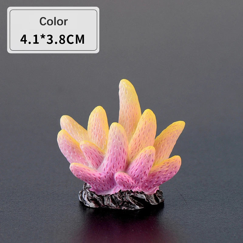 A small, bright yellow and pink resin coral decoration with a dark base.