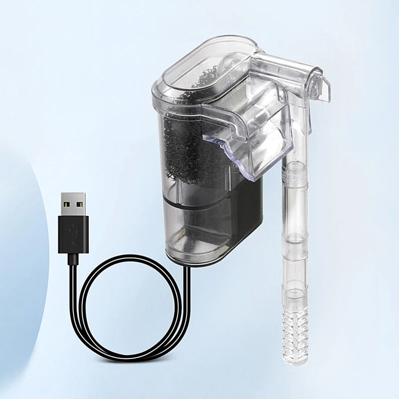 A clear plastic aquarium filter with a black USB connector and flexible hose is shown against a light blue background.