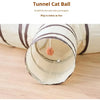 A beige fabric tunnel for cats is shown, with a fluffy pom-pom at the entrance.